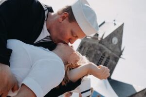 homme embrassant une photo avec église en arrière-plan french kiss lors du D-Day / crédit studios numériques